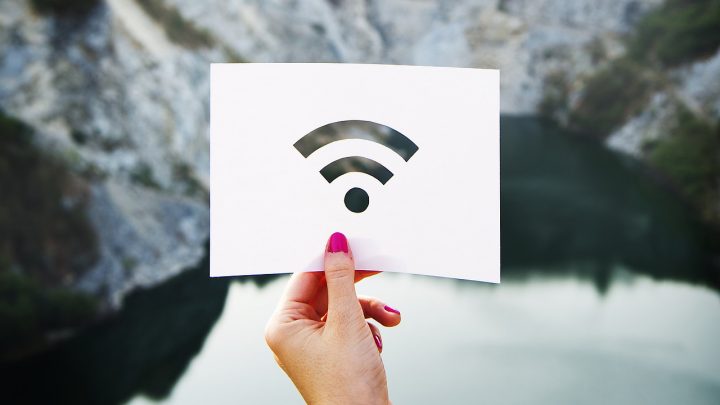 Photo of someone holding up a wifi icon