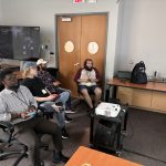 A group of Summer Day participants play video games together